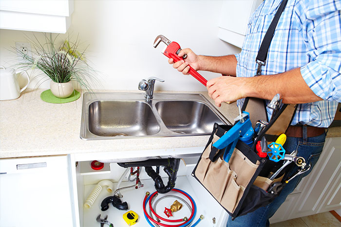 man preparing to fix a sink